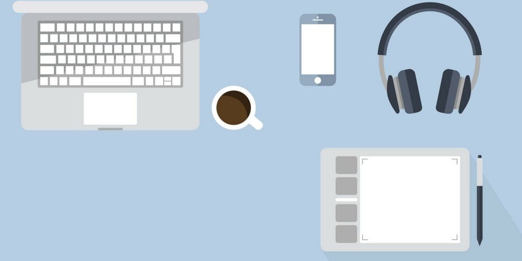 An illustration of a laptop and other web designer tools on a desk — Should I Pay Someone to Design My Website?
