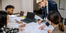 What is inbound marketing? A practical definition for business owners Marketing team reviewing campaign data and planning materials around a table.