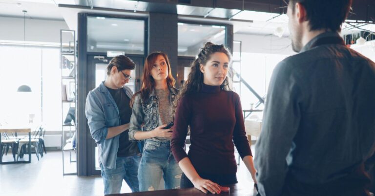 People waiting in line at a service counter, illustrating inbound marketing tools that help attract and engage customers.