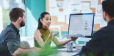 Online marketing goals that actually guide your campaigns Marketing team reviewing campaign performance and discussing results around a computer.