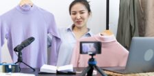 Small business owner presenting clothing products during an online video or livestream.