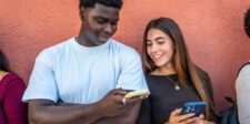 9 content marketing stats every small business should know Two people looking at smartphones together while discussing digital content.