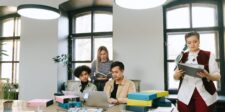 Where to market your small business today Small business team reviewing marketing materials and working together around a laptop.