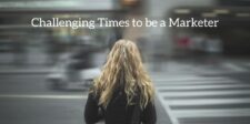 Mars marketing chief: why disruption is still the marketer’s reality Graphic showing a woman standing at a crosswalk with blurred traffic in the background and the headline, “Challenging Times to be a Marketer.”