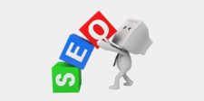 3D figure stacking colorful blocks that spell “SEO.”