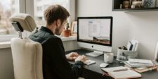 Person working at a desktop computer in a home office, representing SEO work and website optimization