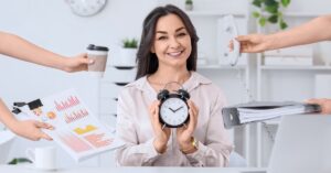 Business owner holding an alarm clock while juggling competing demands including calls, reports, paperwork and coffee.