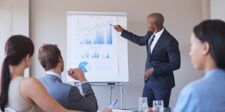 10 tips for an error-free business plan presentation Business professional presenting charts and financial projections to a small group during a business plan presentation.