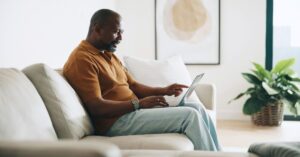 Small-business owner working on website copy on a laptop from home.