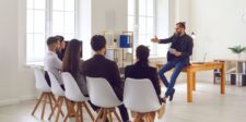 How Google uses sitewide signals to understand pages Digital marketing professional presenting website strategy to a team during a group discussion.