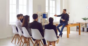 Digital marketing professional presenting website strategy to a team during a group discussion.