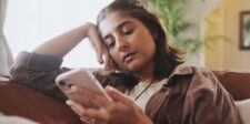More than half of U.S. TikTok users now get news on the app Woman scrolling on a smartphone, illustrating how people increasingly encounter news through TikTok and social media feeds.
