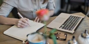 A woman working on a writing project, possibly making use of power words.