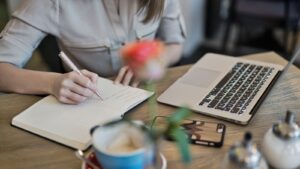 A woman working on a writing project, possibly making use of power words.