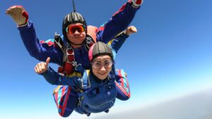 A man and a woman sky diving