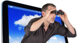 A man with binoculars sticking his head out of a screen - Helpful Content Update