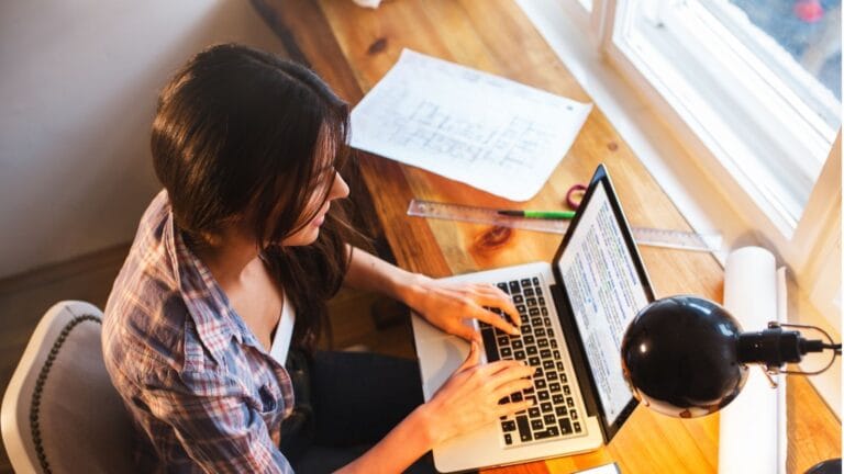 A female blogger is writing on the computer