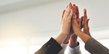 A diverse group of professionals giving a high-five, symbolizing teamwork, achievement, and collective success. This image captures the essence of collaboration and mastering the fundamentals for success.