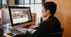 Man focused on a computer screen during maker time, exemplifying productivity and creativity. Balancing maker time and manager time is crucial for optimizing business success.