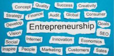 A graphic featuring the word "Entrepreneurship" prominently displayed in the center, surrounded by various related terms such as "Strategy," "Finance," "Innovation," "Marketing," "Success," and "Creativity." Each word is written on torn pieces of paper arranged against a blue background. The overall design conveys the diverse aspects of entrepreneurship and the resources needed to unlock success in this field.