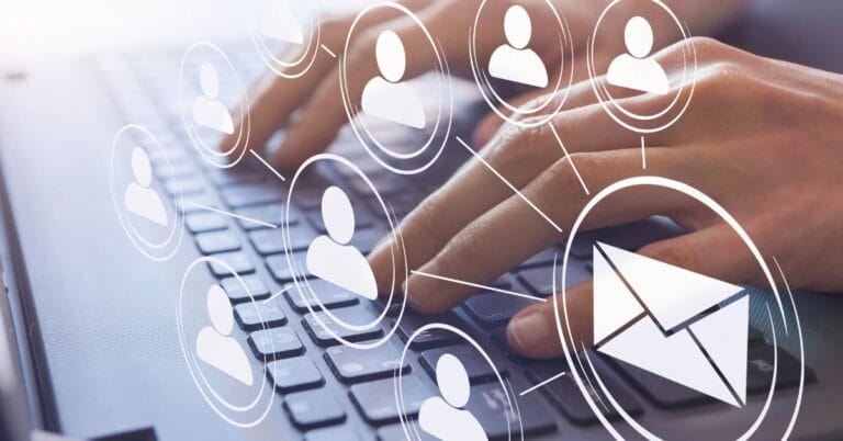 Hands typing on a keyboard with digital icons of people and an envelope, representing the concept of sending an eblast for mass communication.