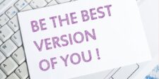 Motivational stoic quotes encouraging personal growth, with 'Be the Best Version of You!' displayed on a card over a keyboard.