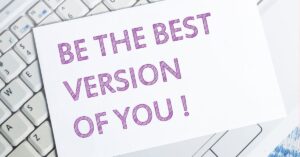 Motivational stoic quotes encouraging personal growth, with 'Be the Best Version of You!' displayed on a card over a keyboard.