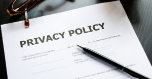 Privacy Policy document with a pen and glasses, representing legal agreements and compliance, relevant to the Avast FTC settlement over privacy concerns. This image reflects the importance of privacy policies in regulatory actions.