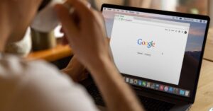 A person viewing the Google homepage on a laptop, symbolizing trust and reliability associated with the Google Guarantee program. The image conveys a focus on secure searches and trusted services.