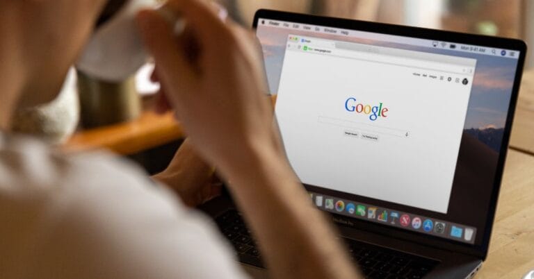A person viewing the Google homepage on a laptop, symbolizing trust and reliability associated with the Google Guarantee program. The image conveys a focus on secure searches and trusted services.