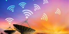 Satellite dishes pointing towards a colorful sunset sky with Wi-Fi symbols above, representing connectivity. This image illustrates methods for obtaining free data and internet access through various sources and strategies.