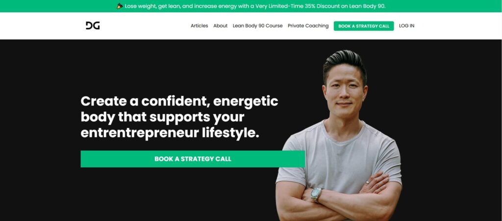 Fitness coach promoting an energetic, confident lifestyle for entrepreneurs. The image features a man standing with arms crossed against a black background, wearing a casual gray T-shirt, with a text overlay encouraging individuals to create a body that supports an entrepreneurial lifestyle. A green button labeled 'Book a Strategy Call' is displayed below the message.