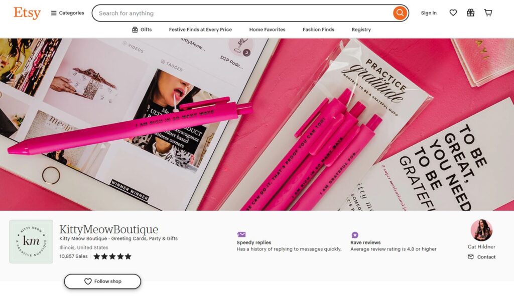 KittyMeow Boutique's Etsy storefront showcasing a vibrant pink theme with gratitude-themed products, including pens and motivational cards. The boutique offers greeting cards, party supplies, and gifts, with a strong emphasis on positivity and empowerment. KittyMeow Boutique is based in Illinois, United States, with over 10,000 sales and a 5-star average review rating, owned by Cat Hildner