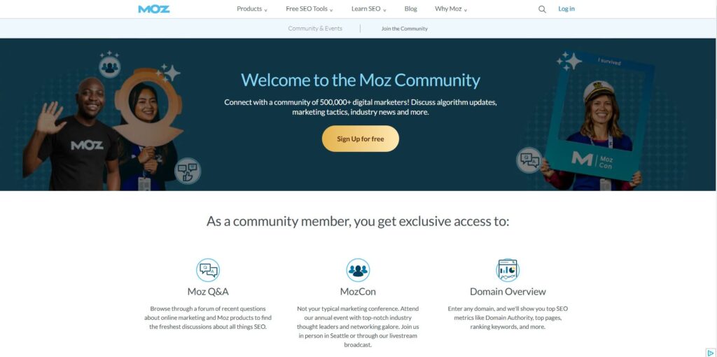 Screenshot of the Moz Community welcome page. The header reads 'Welcome to the Moz Community,' inviting users to join a network of over 500,000 digital marketers to discuss algorithm updates, marketing tactics, and industry news. The image features two Moz community members smiling and posing with props. Below, the page outlines exclusive community benefits, including Moz Q&A, MozCon, and Domain Overview, offering resources like forums, conferences, and SEO tools.