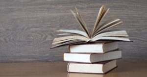 stack of books on a brown table