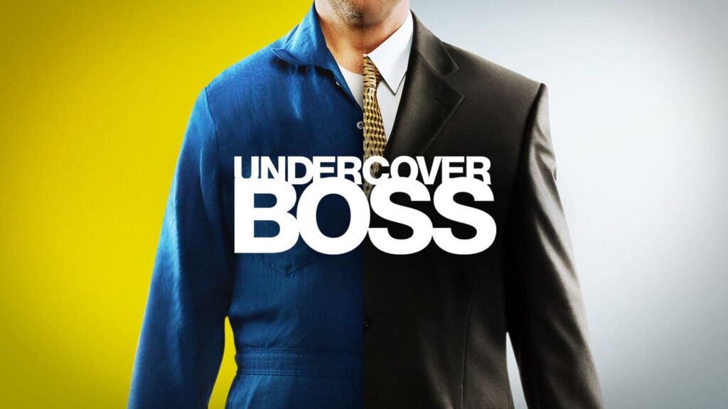 Poster for "Undercover Boss," featuring a split image of a man wearing a worker’s uniform on one side and a business suit on the other, symbolizing the show's exploration of CEOs discovering their employees' experiences.