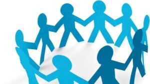 A circle of connected blue paper-cut figures symbolizing community, collaboration, and active participation.