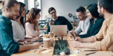 A diverse team engaged in a collaborative meeting around a table.