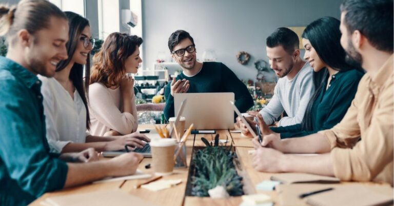A diverse team engaged in a collaborative meeting around a table.
