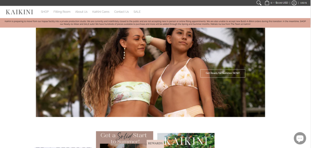 Two women in stylish bikinis enjoying a tropical setting.