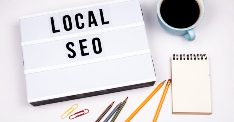 Lightbox displaying "Local SEO" beside pencils, a notebook, and a cup of coffee.