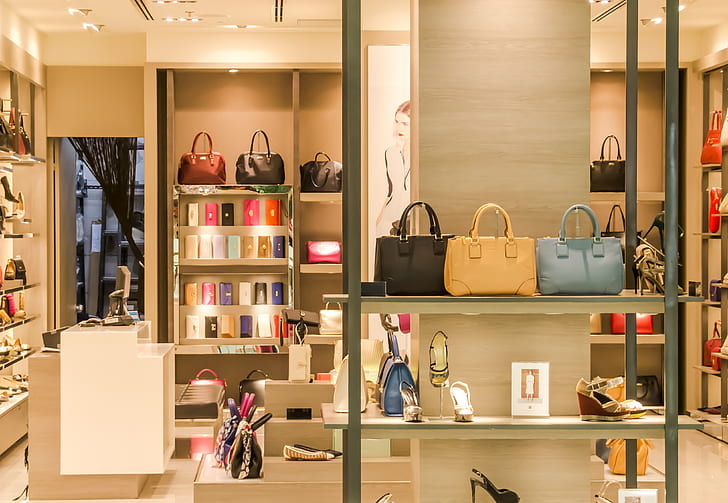 Luxurious retail store display with handbags and shoes.