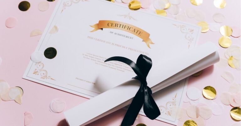 Certificate of achievement with a rolled-up scroll tied with a black ribbon, surrounded by confetti.