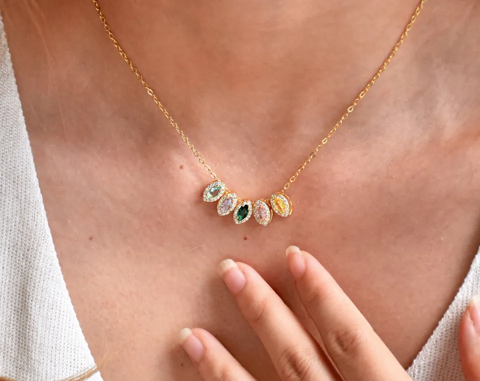 Elegant gold necklace with colorful gemstone pendants.