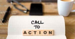 "Call to Action concept on notepad with scrabble letters on a desk."