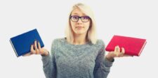 A woman with glasses holding a red book in one hand and a blue book in the other, shrugging as if deciding between them—symbolizing how to deal with someone who has unrealistic expectations by presenting choices.