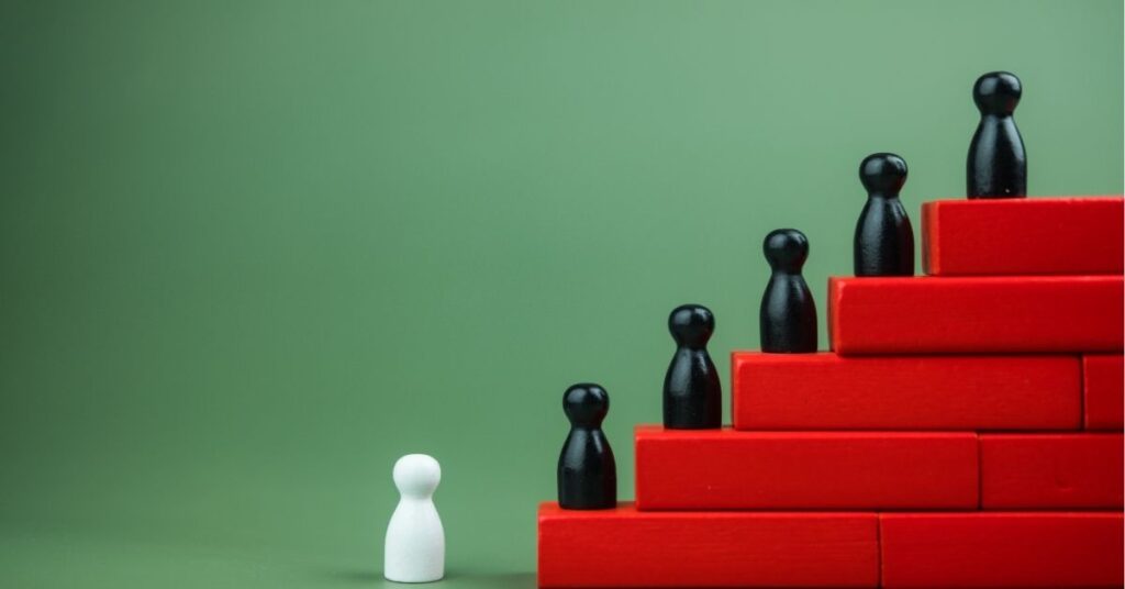 White pawn facing black pawns on a red staircase, symbolizing challenge or progress.