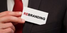 Business card with "Rebranding" in a suit pocket.