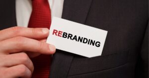 Business card with "Rebranding" in a suit pocket.