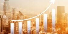 City skyline with a rising bar graph and arrow indicating growth.